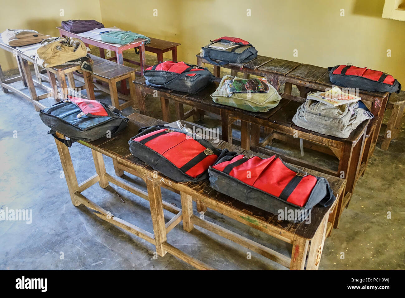 Pupils schools bags on desks India Stock Photo