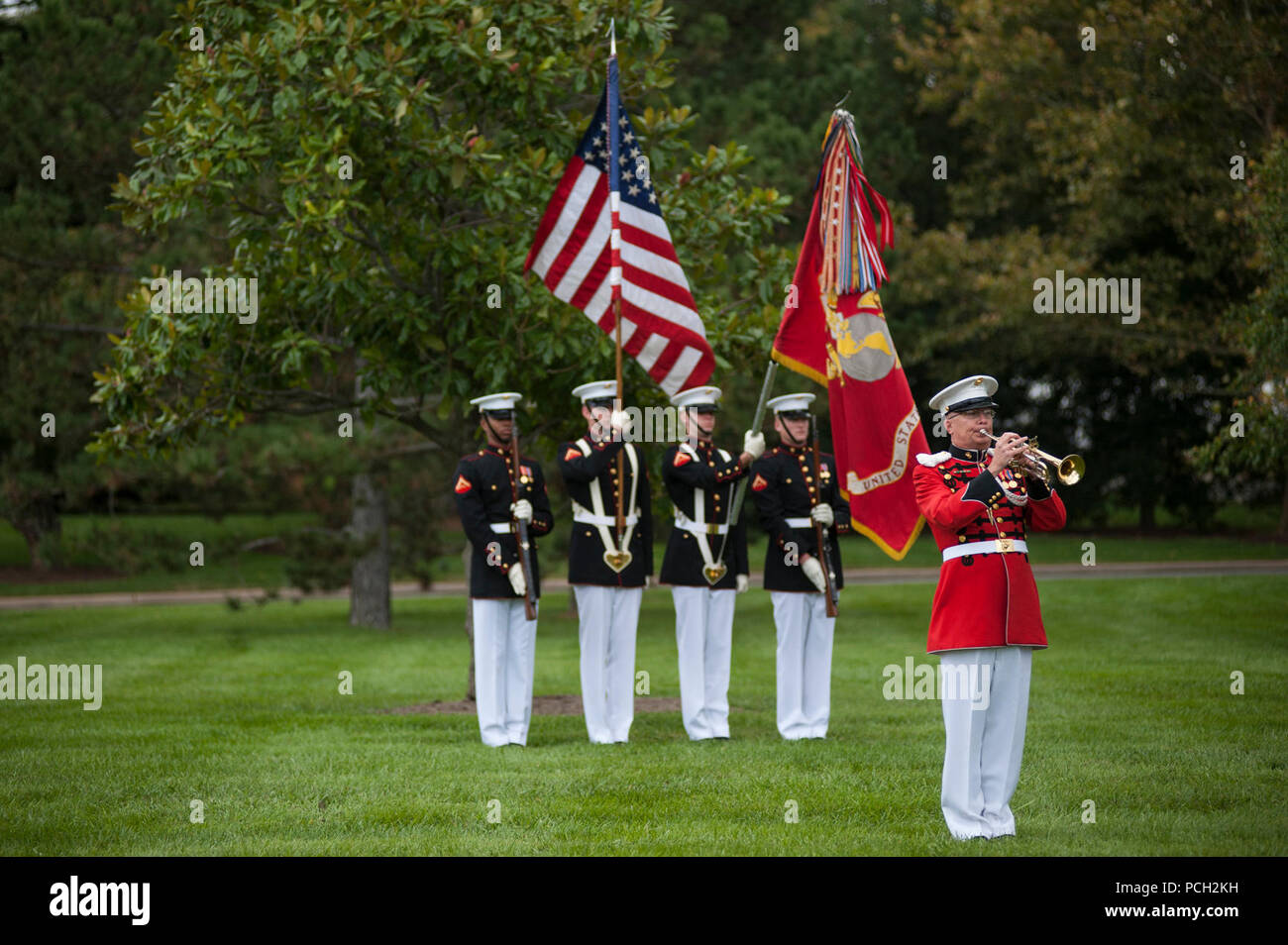 A member from the U.S. Marine Band plays taps during a funeral ceremony at Arlington National Cemetery Oct. 24. The ceremony, supported by Marine Barracks Washington, D.C., was held for a group of six Marines who died in a CH-53 helicopter crash in Afghanistan on January 19, 2012. The deceased are Capt. Daniel Bartle, Capt. Nathan McHone, Master Sgt. Travis Riddick, Cpl. Jesse Stites, Cpl. Kevin Reinhard and Cpl. Joseph Logan. Stock Photo