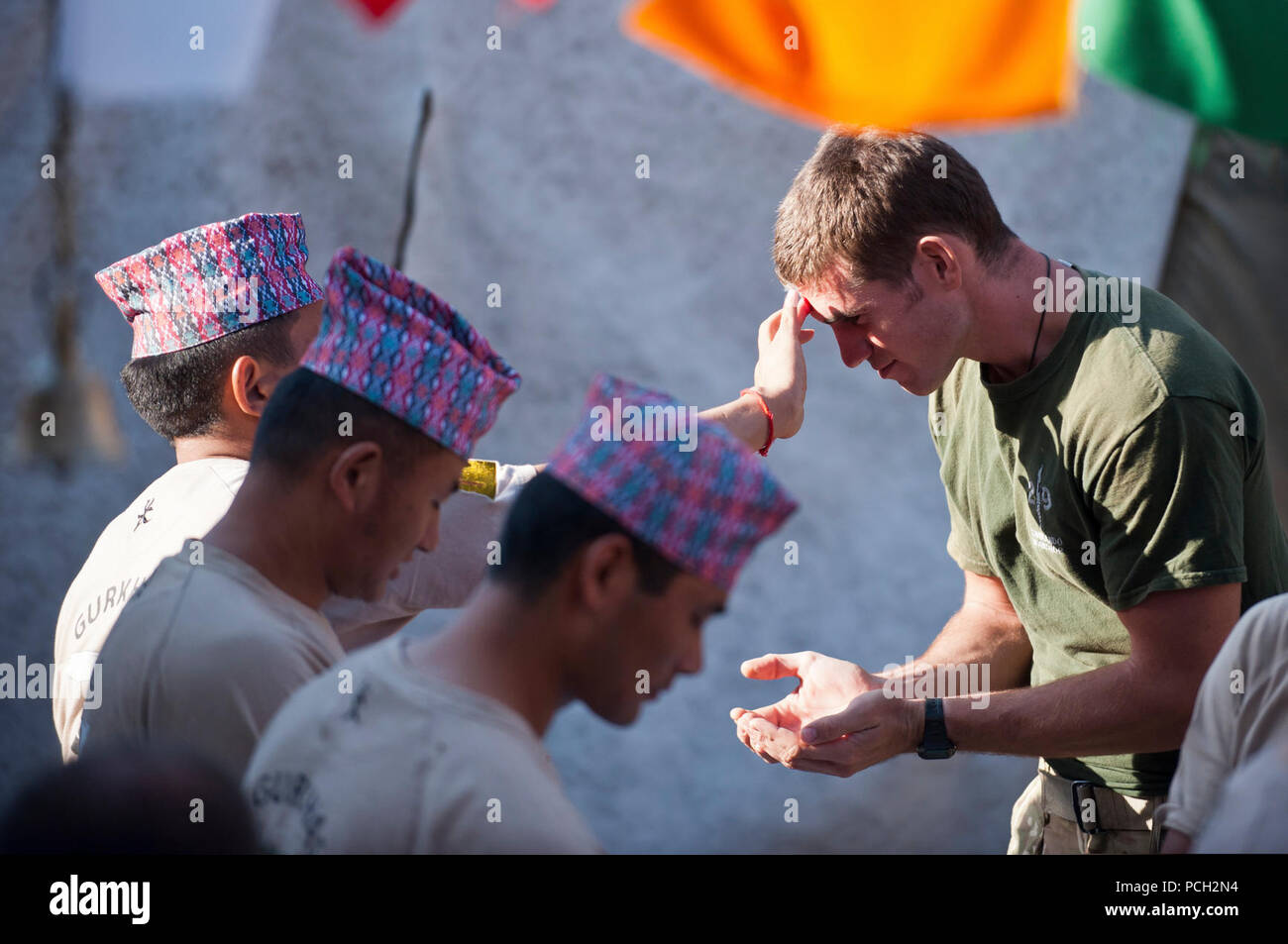 A Nepalese soldier from the Royal Gurkha Rifles regiment of the British army, Brigade of Gurkhas blesses a British soldier during the holy festival of Dashain, at Lashkar Gah district, Helmand province, Sept. 24. The Royal Gurkha Rifles are the only Gurkha unit in the British army. Dashain, a 15-day Nepalese national and religious-festival, and is the country????????s longest and most auspicious festival. Dashain commemorates the victories of the goddess Durga over the demon Mahisasur, goddess Durga is worshiped throughout the kingdom as the divine mother goddess. Stock Photo