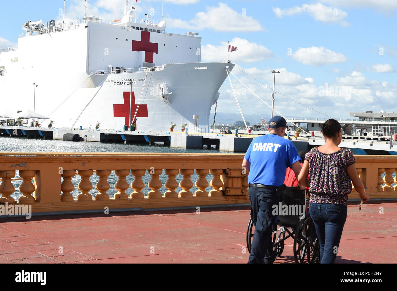 SAN JUAN, Puerto Rico (Nov. 1, 2017) A patient is escorted to the U.S. Department of Health and Human Services medical tent on the pier as the Military Sealift Command hospital ship USNS Comfort (T- AH 20) is moored pierside in San Juan to provide humanitarian relief. The Department of Defense is supporting the Federal Emergency Management Agency, the lead federal agency, in helping those affected by Hurricane Maria to minimize suffering and is one component of the overall whole-of-government response effort. Stock Photo