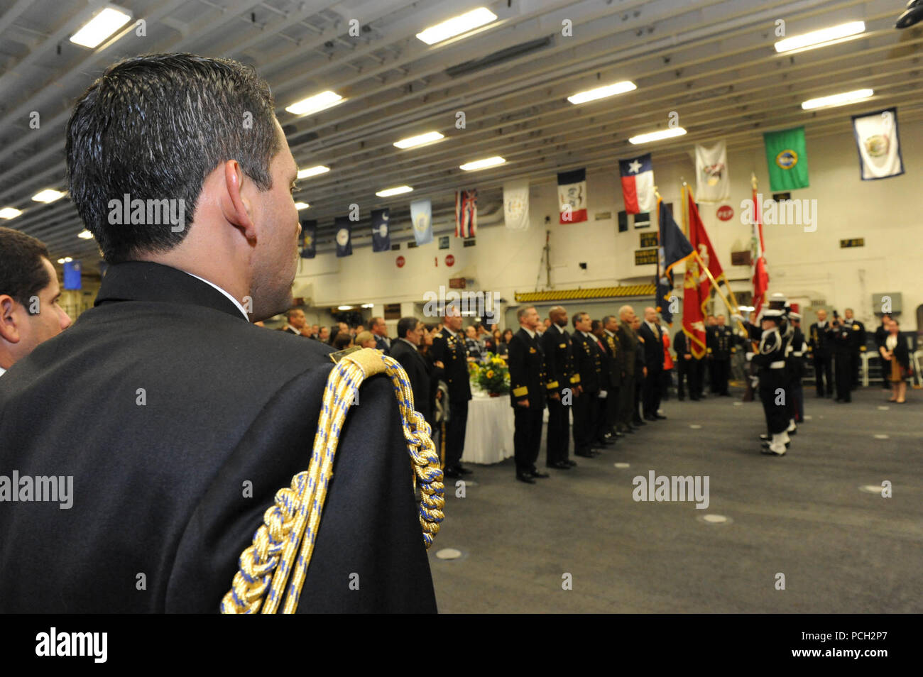 A Peruvian naval officer stands at attention during a reception on the amphibious assault ship USS America (LHA 6) in Callao, Peru, Sept. 1, 2014. The America embarked on a mission to conduct training engagements with partner nations throughout the Americas before reporting to its new home port of San Diego. The America was set to be ceremoniously commissioned Oct. 11, 2014. Stock Photo