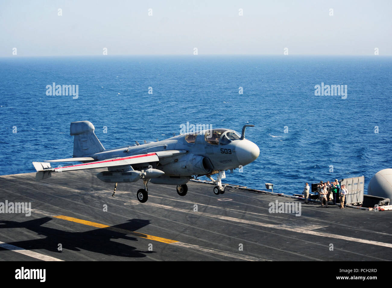 ARABIAN GULF (July 21, 2014) An EA-6B Prowler assigned to the Garudas of Electronic Attack Squadron (VAQ) 134 prepares to land on the flight deck of the aircraft carrier USS George H.W. Bush (CVN 77). George H.W. Bush is supporting maritime security operations and theater security cooperation efforts in the U.S. 5th Fleet area of responsibility. Stock Photo