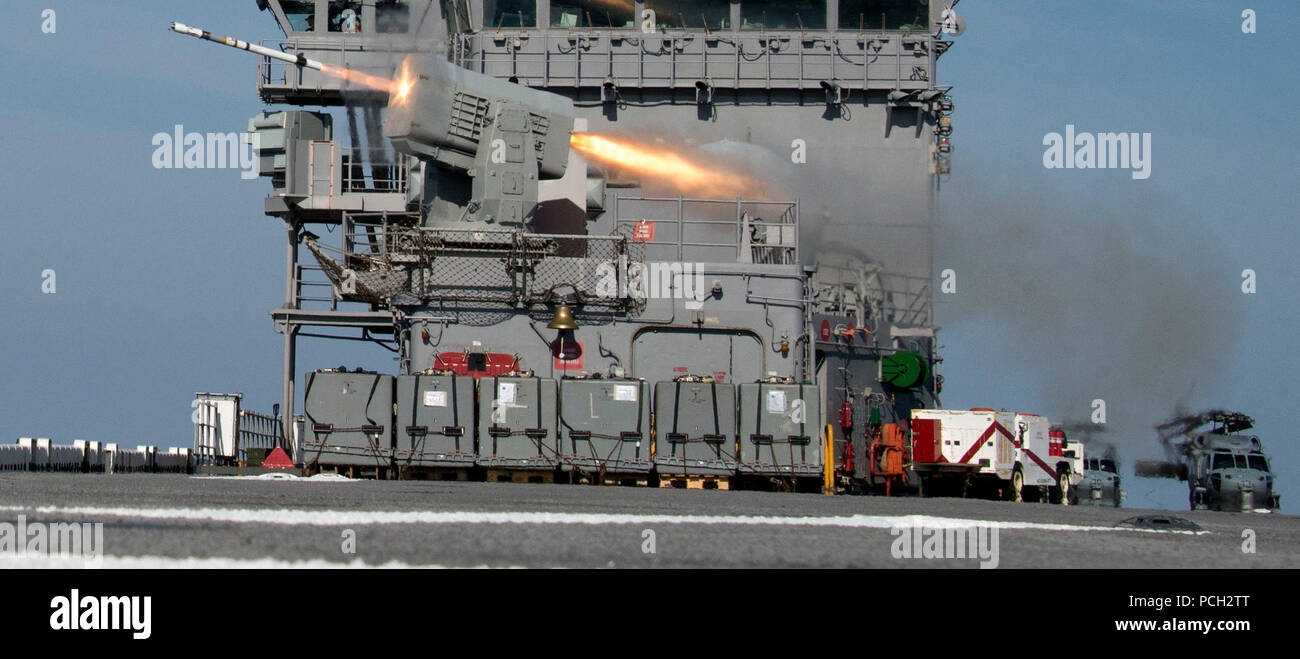 ATLANTIC OCEAN (Feb. 9, 2018) A rolling airframe missile is launched from the forward missile battery of the amphibious assault ship USS Iwo Jima (LHD 7) during a missile exercise. The Iwo Jima Amphibious Ready Group (ARG) is deployed in support of maritime security operations and theater security cooperation efforts in Europe and the Middle East. The Iwo Jima ARG embarks the 26th Marine Expeditionary Unit (MEU) and includes Iwo Jima, the amphibious transport dock ship USS New York (LPD 21), the dock landing ship USS Oak Hill (LSD 51), Fleet Surgical Team 8, Helicopter Sea Combat Squadron 28,  Stock Photo
