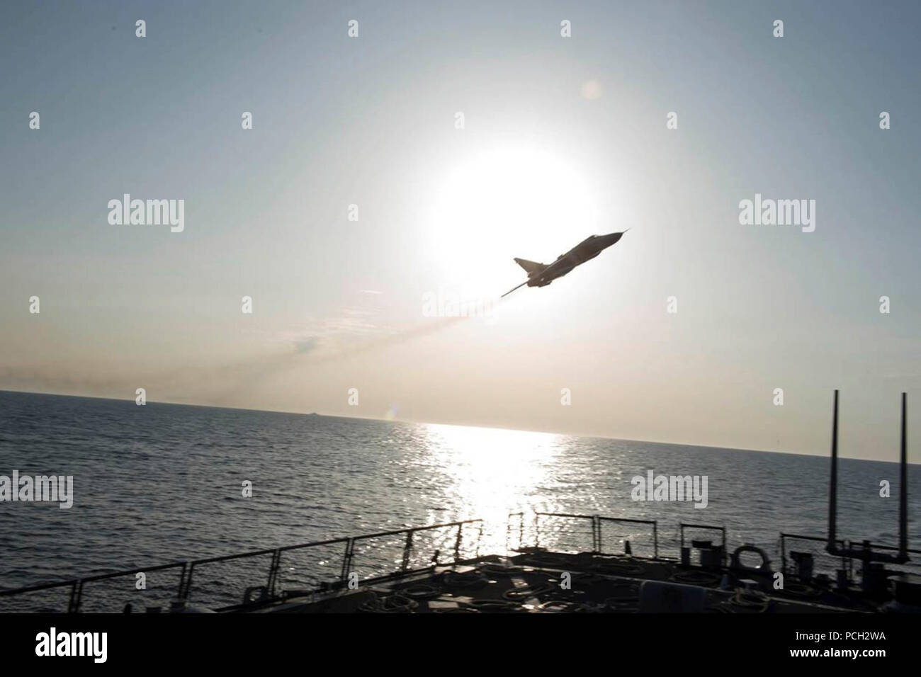 BALTIC SEA (April 12, 2016) A Russian Sukhoi Su-24 attack aircraft makes a low altitude pass by USS Donald Cook (DDG 75) April 12, 2016. Donald Cook, an Arleigh Burke-class guided-missile destroyer forward deployed to Rota, Spain, is conducting a routine patrol in the U.S. 6th Fleet area of operations in support of U.S. national security interests in Europe. Stock Photo