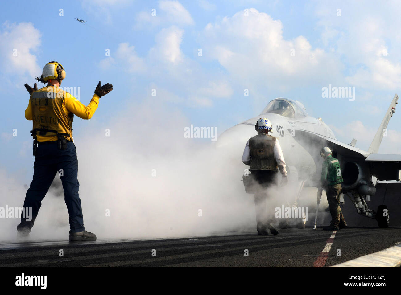 U.S. 5TH FLEET AREA OF RESPONSIBILITY (Dec. 30, 2012) Aviation Boatswain's Mate (Handling) 3rd Class Jason Spencer, from Colombus, Ohio, directs an F/A-18C Hornet from the Golden Dragons of Strike Fighter Squadron (VFA) 192 on the flight deck aboard the aircraft carrier USS John C. Stennis (CVN 74). John C. Stennis is deployed to the U.S. 5th Fleet area of responsibility conducting maritime security operations, theater security cooperation efforts and support missions for Operation Enduring Freedom. Stock Photo