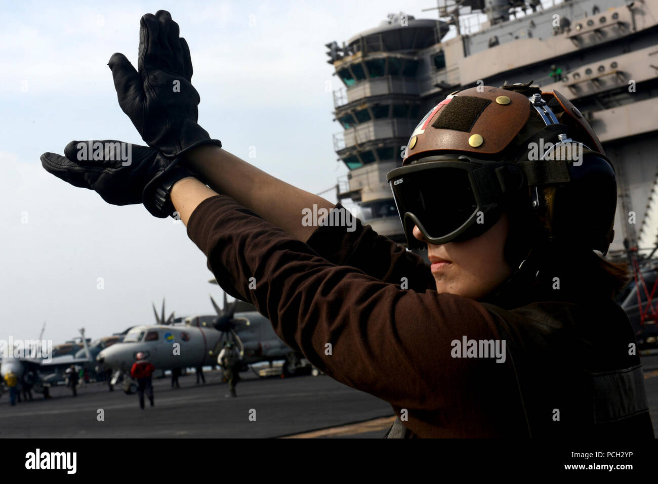 U.S. 5TH FLEET AREA OF RESPONSIBILITY (Jan. 26, 2013) Aviation Machinist's Mate Airman Alexandria King signals for an aircraft to test it's flaps aboard the aircraft carrier USS John C. Stennis (CVN 74). John C. Stennis is deployed to the U.S. 5th Fleet area of responsibility conducting maritime security operations, theater security cooperation efforts and support missions for Operation Enduring Freedom. Stock Photo