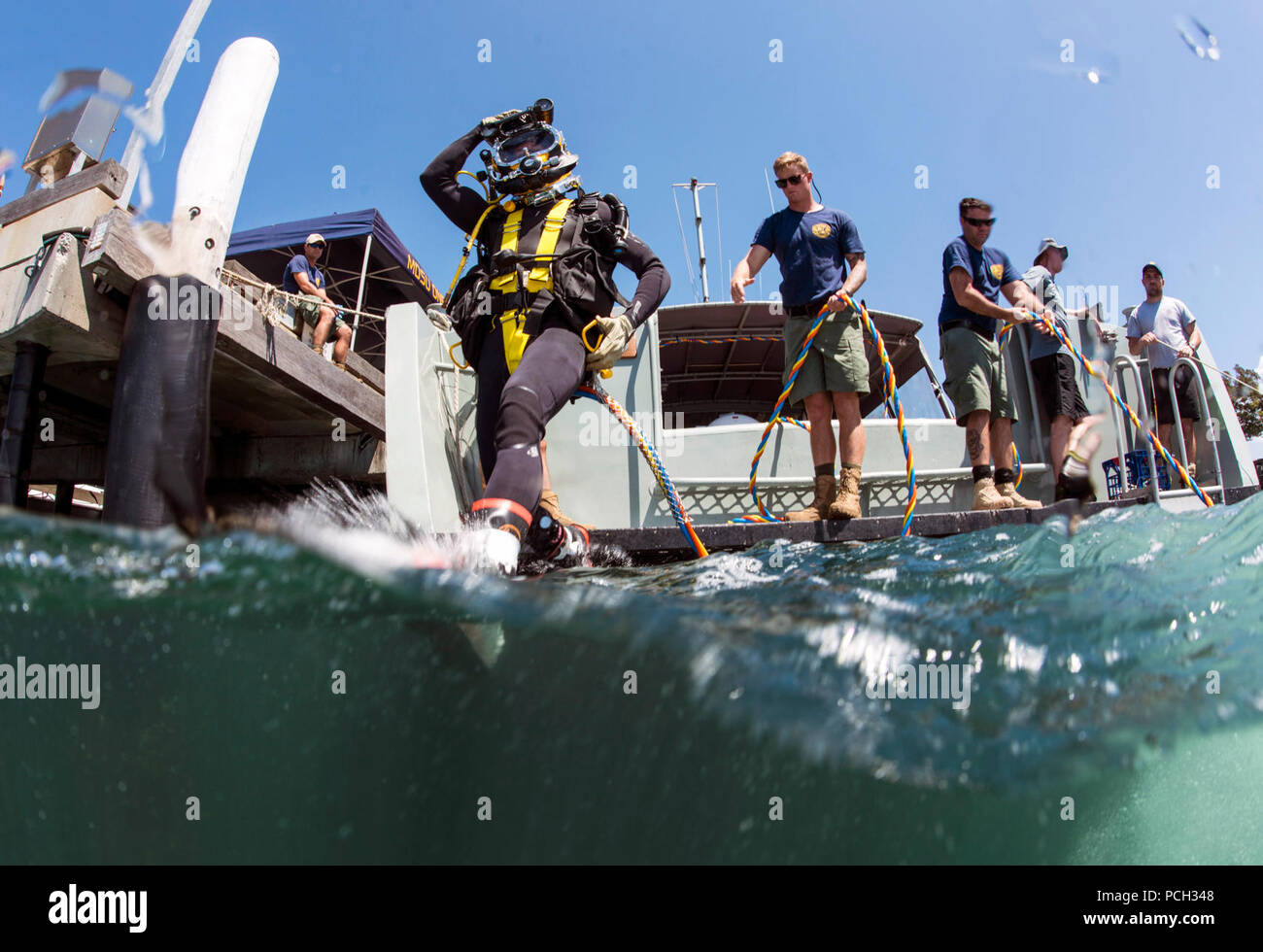 Petty Officer 2nd Class Corbin Stinson, assigned to Mobile Diving Salvage Unit (MDSU) 1, enters the water for a dive during Exercise Dugong 2016, in Sydney, Australia, Nov. 10, 2016. Dugong is a bi-lateral U.S Navy and Royal Australian Navy training exercise, advancing tactical level U.S. service component integration, capacity, and interoperability with Australian Clearance Diving Team (AUSCDT) ONE. Stock Photo