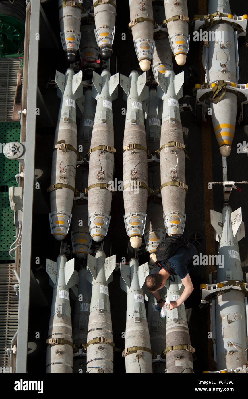 GULF OF OMAN (June 22, 2013) A Sailor maintains and cleans ordnance aboard the aircraft carrier USS Nimitz (CVN 68). The Nimitz Carrier Strike Group is deployed to the U.S. 5th Fleet area of responsibility conducting maritime security operations, theater security cooperation efforts and support missions for Operation Enduring Freedom. Stock Photo