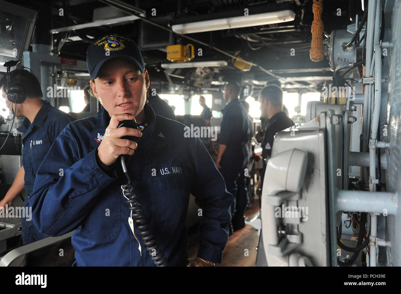 PHILIPPINE SEA (Nov. 4, 2012) Boatswain’s Mate 3rd Class Ashley Norman, assigned to the Arleigh Burke-class guided-missile destroyer USS McCampbell (DDG 85), passes a message for the crew over the ship’s 1MC in the pilot house. McCampbell is part of the George Washington Carrier Strike Group, the U.S. Navy’s only continuously forward-deployed carrier strike group, based out of Yokosuka, Japan, and is currently conducting a routine western Pacific patrol in support of regional security and stability of the vital Asia-Pacific region. Stock Photo