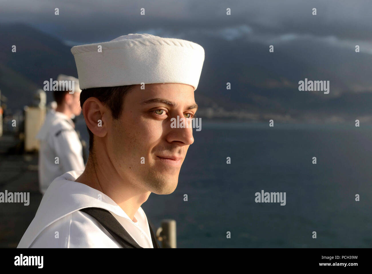 GAETA, Italy (Oct. 3, 2015) Information Systems Technician 3rd Class Michael Tontz mans the rails as the U.S. 6th Fleet command and control ship USS Mount Whitney (LCC 20) pulls into Gaeta, Italy after a nine month dry-dock period in Rijeka, Croatia. Mount Whitney, forward deployed to Gaeta, Italy, operates with a combined crew of U.S. Navy Sailors and Military Sealift Command civil service mariners. Stock Photo