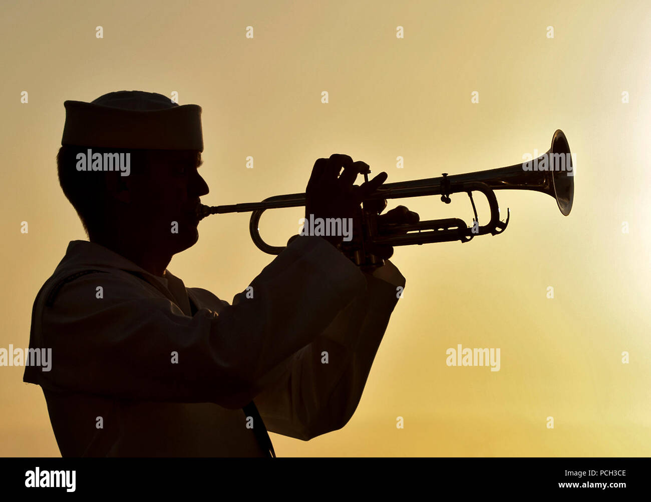 PEARL HARBOR (Dec. 6, 2012) Musician 3rd Class Shelby Tucci, assigned to the Pacific Fleet Band, plays Taps during a sunset ceremony at the USS Utah Memorial, Joint Base Pearl Harbor-Hickam. Utah was sunk during the surprise Japanese attacks on Pearl Harbor on Dec. 7, 1941. Stock Photo