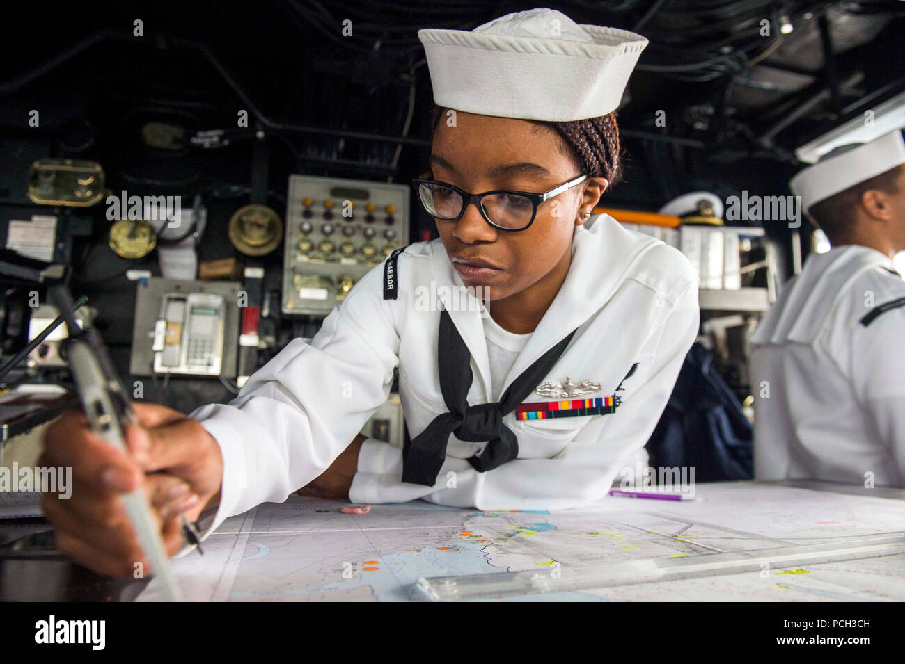 Sri Lanka (March 27, 2017) Quartermaster 3rd Class Tyler Terrell, from Atlanta, plots a course on the bridge of the amphibious dock landing ship USS Comstock (LSD 45) as the ship arrives in Colombo, Sri Lanka, to conduct theater security cooperation events with the Sri Lankan Navy and Marine Corps. Comstock, part of the Makin Island Amphibious Ready Group, with the embarked 11th Marine Expeditionary Unit, is on a scheduled deployment to the U.S. 7th Fleet area of operations. Stock Photo