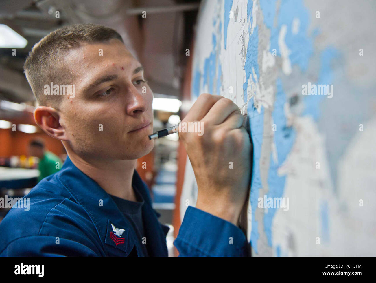 ATLANTIC OCEAN (July 28, 2012) Quartermaster 1st Class Joshua Koenig reviews a map aboard the Ticonderoga-class guided-missile cruiser USS Cape St. George (CG 71). Cape St. George is deployed as part of Carrier Strike Group 9, and is operating in the U.S. 6th Fleet area of responsibility in support of maritime security operations and theater security cooperation efforts. Stock Photo