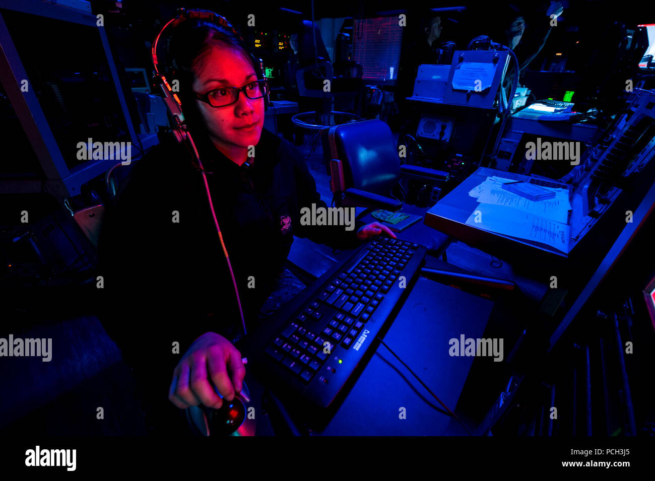 CORAL SEA (Aug. 9, 2013) Operations Specialist 2nd Class Marlene Hernandez monitors radar signatures in the combat operations center aboard the amphibious assault ship USS Bonhomme Richard (LHD 6). Bonhomme Richard is the flagship of the Bonhomme Richard Amphibious Ready Group and, with the embarked 31st Marine Expeditionary Unit (31st MEU), is conducting a certification exercise in the U.S. 7th Fleet area of responsibility. Stock Photo