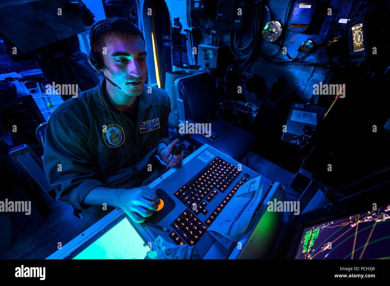 CORAL SEA (Aug. 9, 2013) Air Traffic Controller 2nd Class Joshua McClellan tracks radar signatures in the air traffic control room aboard the amphibious assault ship USS Bonhomme Richard (LHD 6). Bonhomme Richard is the flagship of the Bonhomme Richard Amphibious Ready Group and, with the embarked 31st Marine Expeditionary Group (31st MEU), is conducting a certification exercise in the U.S. 7th Fleet area of responsibility. Stock Photo