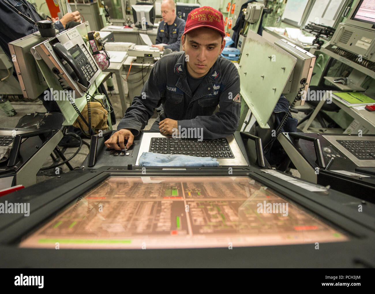 PACIFIC OCEAN (Jan. 30, 2015) Hull Maintenance Technician 3rd Class Luis Aguiar mans a engineering control station console in the central control station aboard the San Antonio-class amphibious transport dock ship USS Green Bay (LPD 20). Green Bay is transiting to Sasebo, Japan, to join the U.S. 7th Fleet's forward deployed Naval forces. Green Bay is replacing the decommissioned Austin-class amphibious transport dock ship USS Denver (LPD 9), previously forward-deployed to Sasebo, and will enhance amphibious presence in the U.S. 7th Fleet as part of the U.S. Navy's long-range plan to send the m Stock Photo
