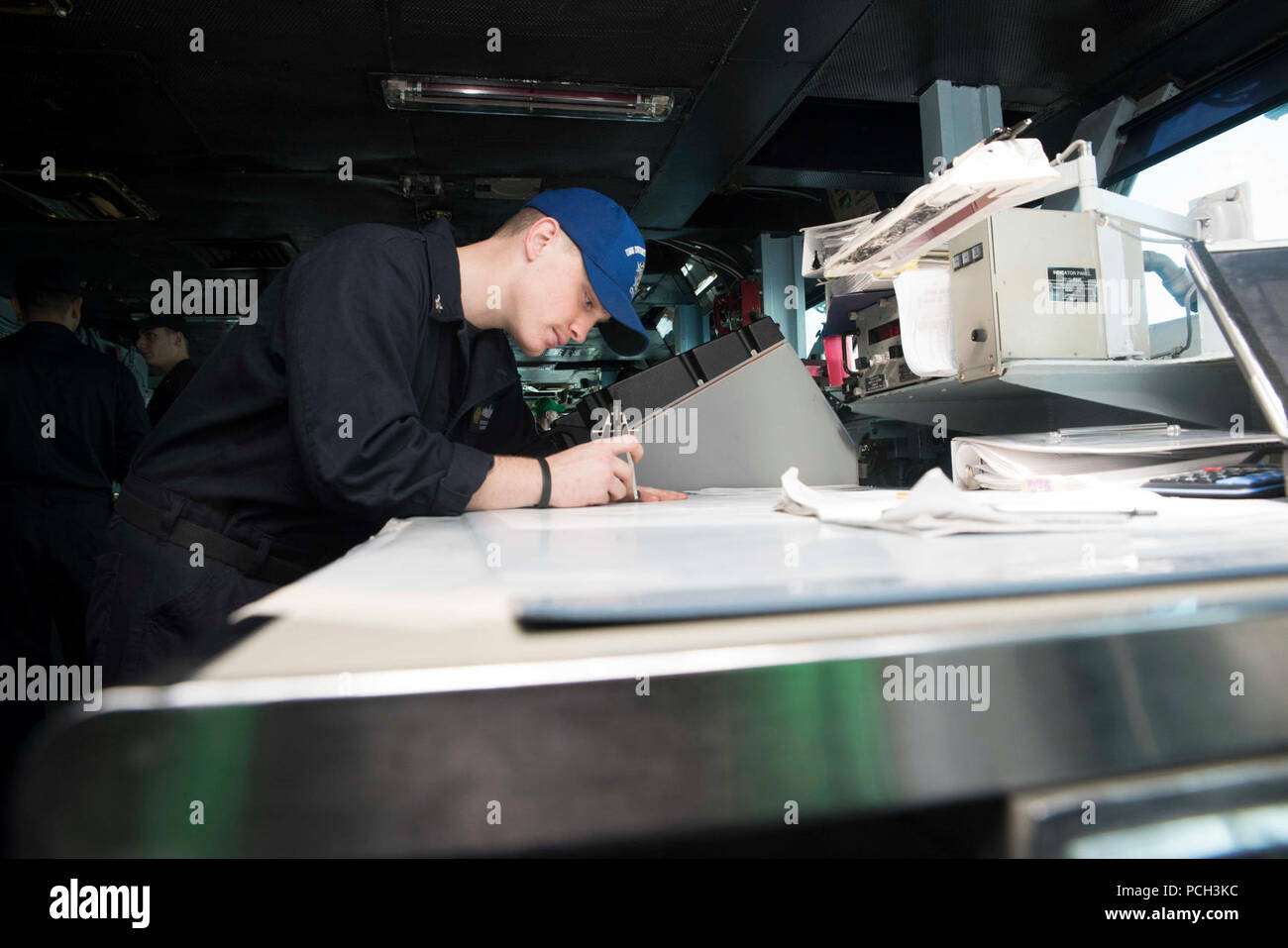 ATLANTIC OCEAN (Dec. 28, 2016) Quartermaster 3rd Class Jesse Sutton, from Dekalb County, Tenn., plots a map on the navigational bridge aboard the aircraft carrier USS Dwight D. Eisenhower (CVN 69). The carrier, currently deployed as part of the Eisenhower Carrier Strike Group, is conducting naval operations in the U.S. 6th Fleet area of operations in support of U.S. national security interests in Europe. Stock Photo