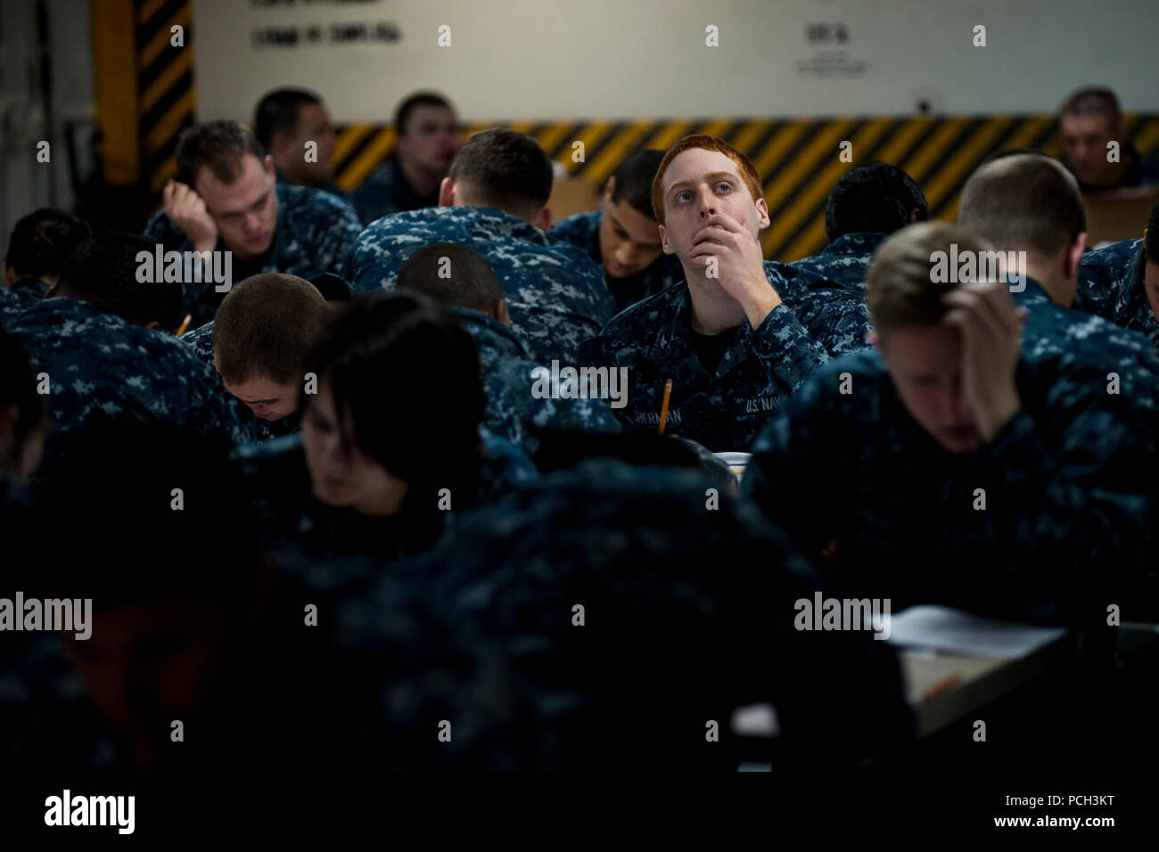 Calif. (March 14, 2013) Third class petty officers take the Navy-wide petty officer 2nd class advancement exam on the mess decks aboard the aircraft carrier USS Carl Vinson (CVN 70). Carl Vinson is pierside at Naval Air Station North Island. Stock Photo