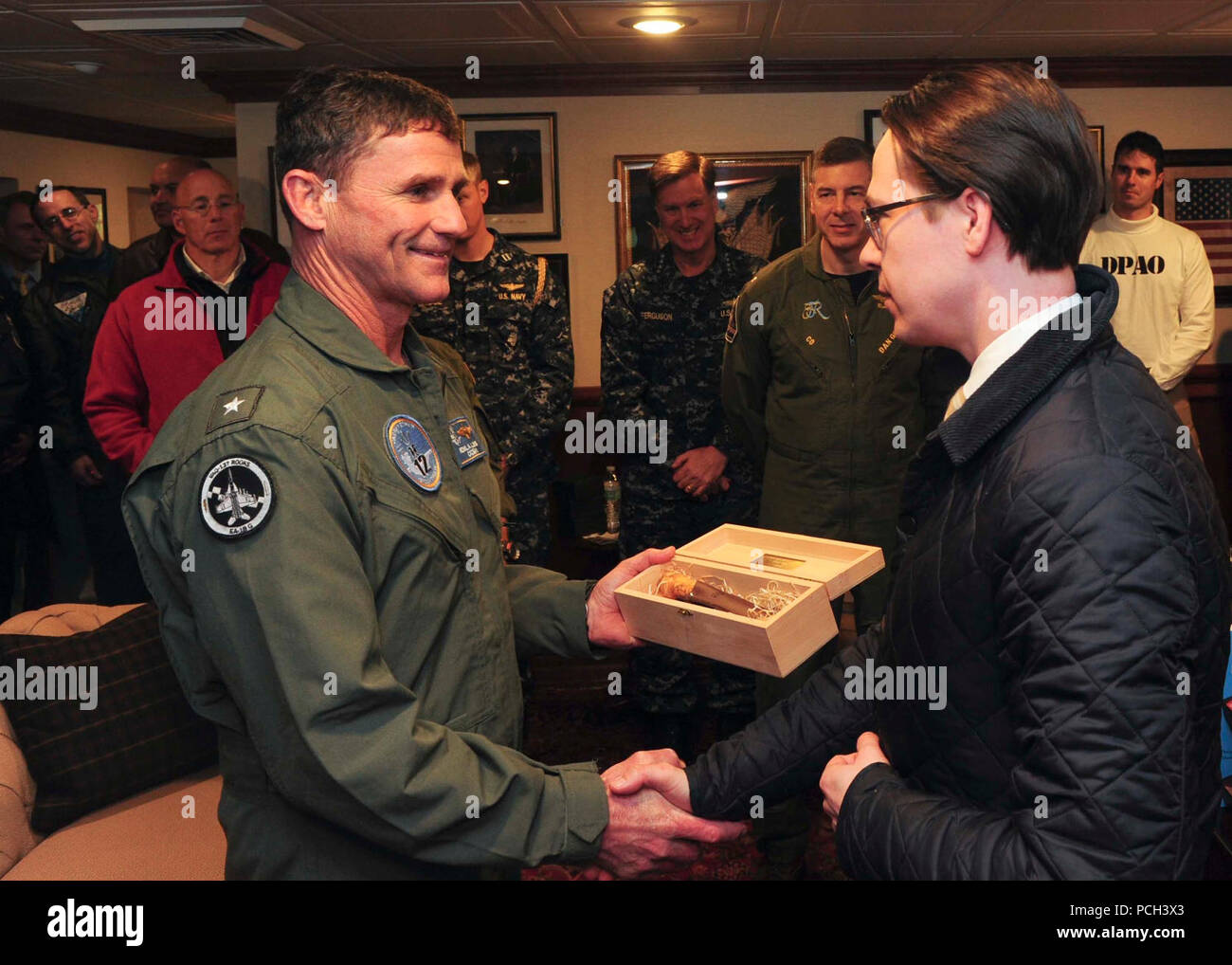 ATLANTIC OCEAN (March 22, 2015) Commander, Carrier Strike Group TWELVE (CCSG 12) Rear Adm. Andrew Lewis, left, receives a token of appreciation from the Finnish Minister of Defence Carl Hagund aboard the Nimitz-class aircraft carrier USS Theodore Roosevelt (CVN 71) March 22, 2015.  Theodore Roosevelt, homeported in Norfolk, is conducting naval operations in the U.S. 6th Fleet area of operations in support of U.S. national security interests in Europe. Stock Photo