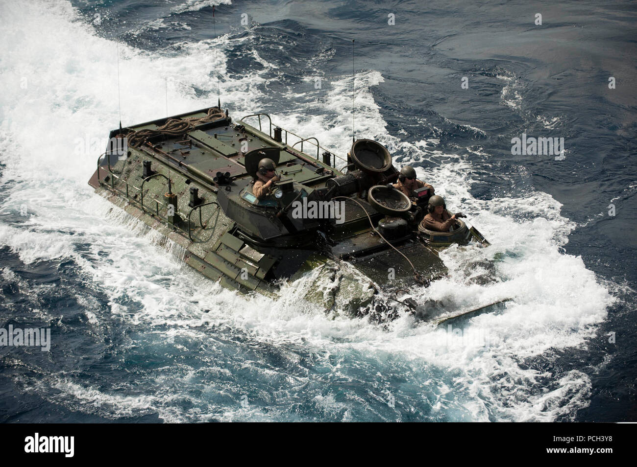 A U.S. Marine Corps assault amphibious vehicle prepares to enter the well deck of the amphibious assault ship USS Bonhomme Richard (LHD 6) in the East China Sea March 11, 2014. The Bonhomme Richard was the lead ship of the Bonhomme Richard Amphibious Ready Group and, with the 31st Marine Expeditionary Unit, was conducting joint force operations in the U.S. 7th Fleet area of responsibility. Stock Photo