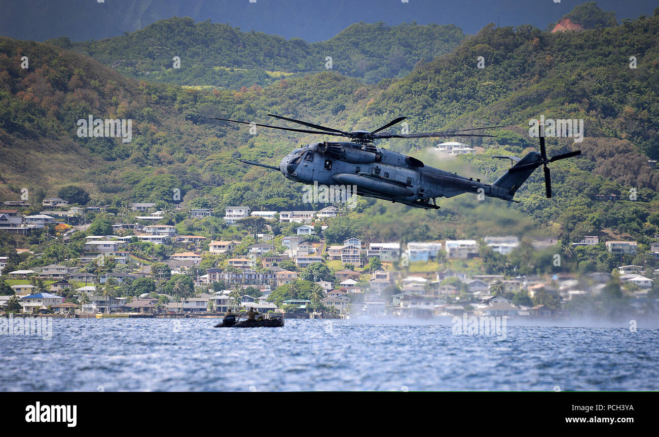 A U.S. Marine Corps CH-53E Super Stallion helicopter assigned to Marine Heavy Helicopter Squadron (HMH) 463 conducts helicopter rope suspension training and amphibious insert capabilities with Marines assigned to the 3rd Marine Division, III Marine Expeditionary Force and Japanese and Canadian soldiers June 30, 2014, in Kaneohe Bay, Hawaii, during Rim of the Pacific (RIMPAC) 2014. RIMPAC is a U.S. Pacific Fleet-hosted biennial multinational maritime exercise designed to foster and sustain international cooperation on the security of the world?s oceans. Stock Photo