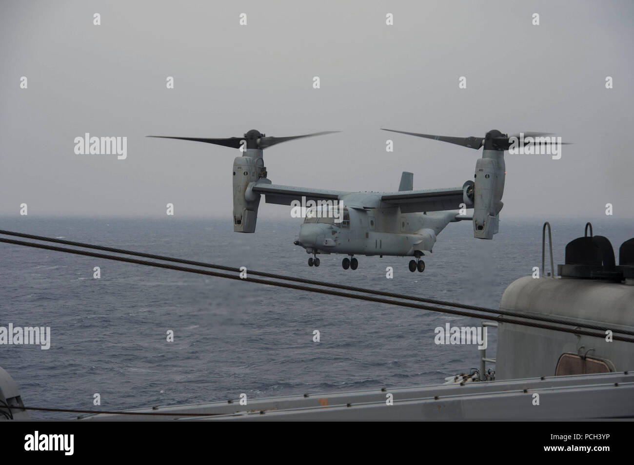 A U.S. Marine Corps MV-22B Osprey tiltrotor aircraft assigned to Marine Medium Tiltrotor Squadron (VMM) 265 prepares to land aboard the amphibious dock landing ship USS Ashland (LSD 48) in the East China Sea March 20, 2014. The Ashland was part of the Bonhomme Richard Amphibious Readiness Group and was underway in the U.S. 7th Fleet area of responsibility supporting maritime security operations and theater security cooperation efforts. Stock Photo