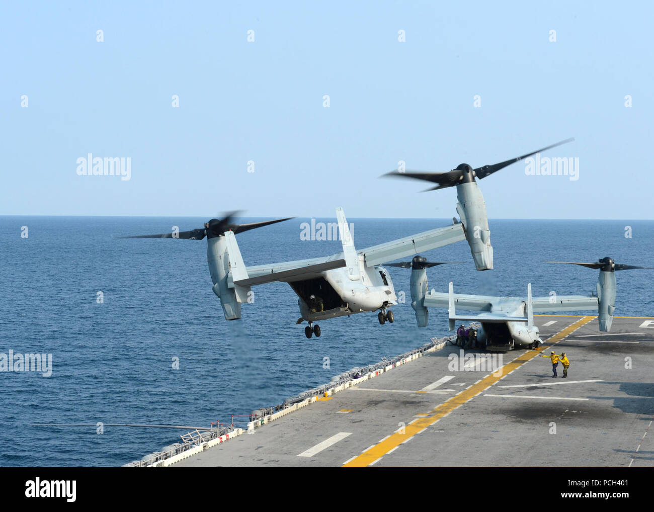 A U.S. Marine Corps MV-22B Osprey tiltrotor aircraft assigned to Marine Medium Tiltrotor Squadron (VMM) 265 takes off from the amphibious assault ship USS Bonhomme Richard (LHD 6) in the East China Sea April 11, 2014. The Bonhomme Richard was underway in the U.S. 7th Fleet area of responsibility supporting maritime security operations and theater security cooperation efforts. Stock Photo