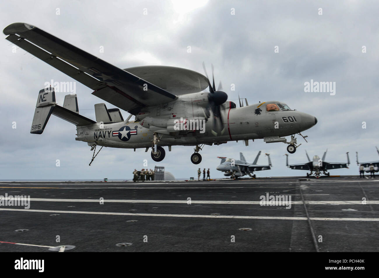A U.S. Navy E2-C Hawkeye aircraft assigned to Carrier Airborne Early Warning Squadron (VAW) 113 lands aboard the aircraft carrier USS Ronald Reagan (CVN 76) March 24, 2014, in the Pacific Ocean. Stock Photo