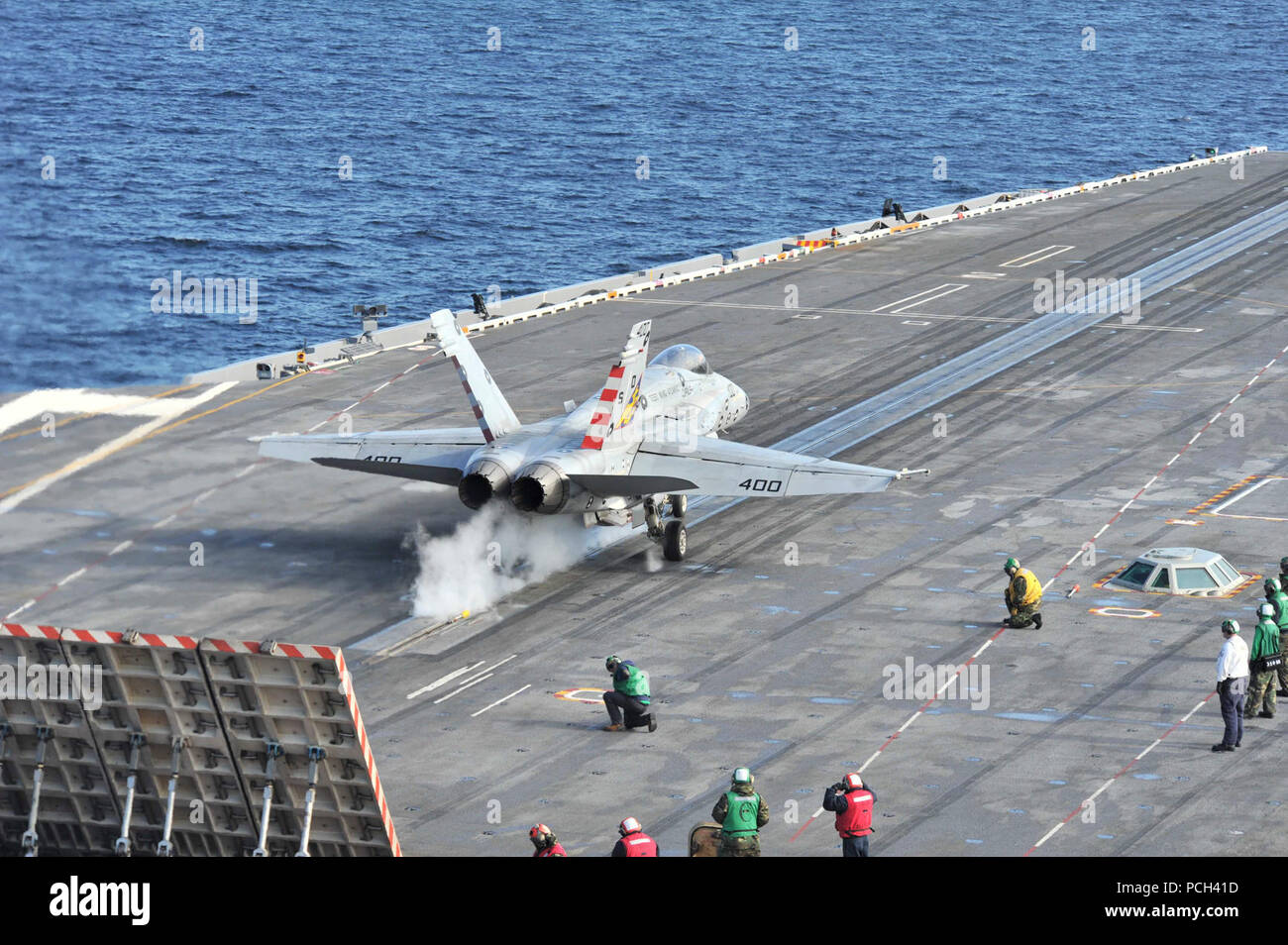 A U.S. Navy F/A-18C Hornet aircraft assigned to Strike Aircraft Test Squadron (VX) 23 takes off from the flight deck of the aircraft carrier USS Theodore Roosevelt (CVN 71) Nov. 16, 2013, in the Atlantic Ocean. VX-23 was conducting tests of the Joint Precision Approach Landing System. Stock Photo