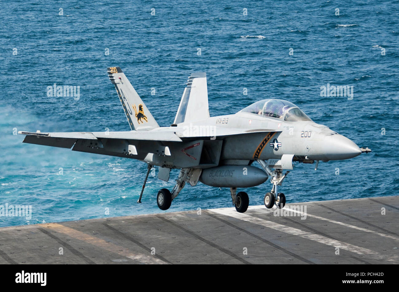 A U.S. Navy F/A-18F Super Hornet aircraft assigned to Strike Fighter Squadron (VFA) 213 lands aboard the aircraft carrier USS George H.W. Bush (CVN 77) in the Persian Gulf Sept. 23, 2014. The George H.W. Bush supported maritime security operations and theater security cooperation efforts in the U.S. 5th Fleet area of responsibility. Stock Photo