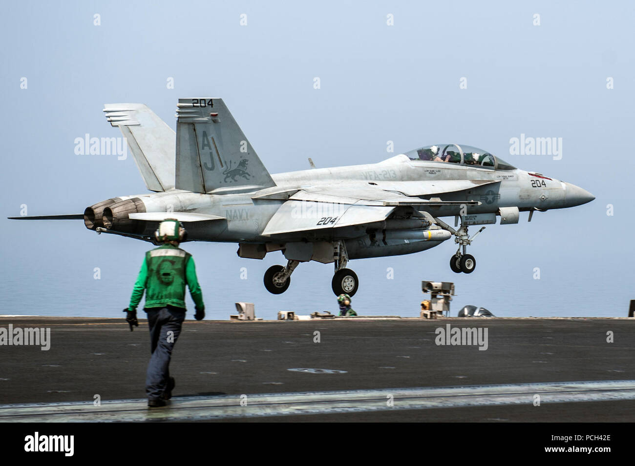 A U.S. Navy F/A-18F Super Hornet aircraft assigned to Strike Fighter Squadron (VFA) 213 lands aboard the aircraft carrier USS George H.W. Bush (CVN 77) Sept. 1, 2014, in the Persian Gulf. The George H.W. Bush was supporting maritime security operations and theater security cooperation efforts in the U.S. 5th Fleet area of responsibility. Stock Photo