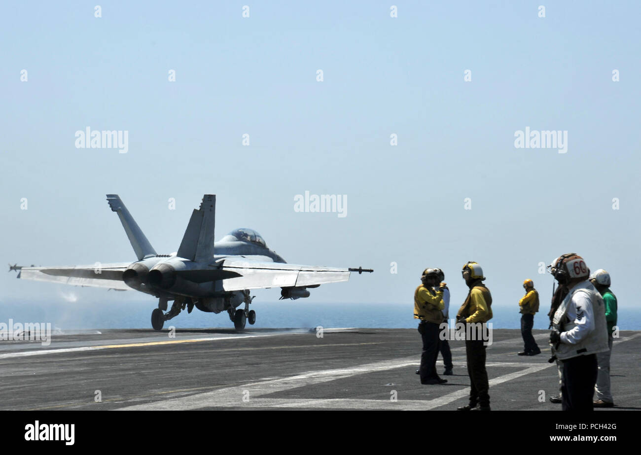 A U.S. Navy F/A-18F Super Hornet aircraft assigned to Strike Fighter Squadron (VFA) 213 takes off from the aircraft carrier USS George H.W. Bush (CVN 77) in the Persian Gulf June 25, 2014. The George H.W. Bush was on a scheduled deployment supporting maritime security operations and theater security cooperation efforts in the U.S. 5th Fleet area of responsibility. Stock Photo