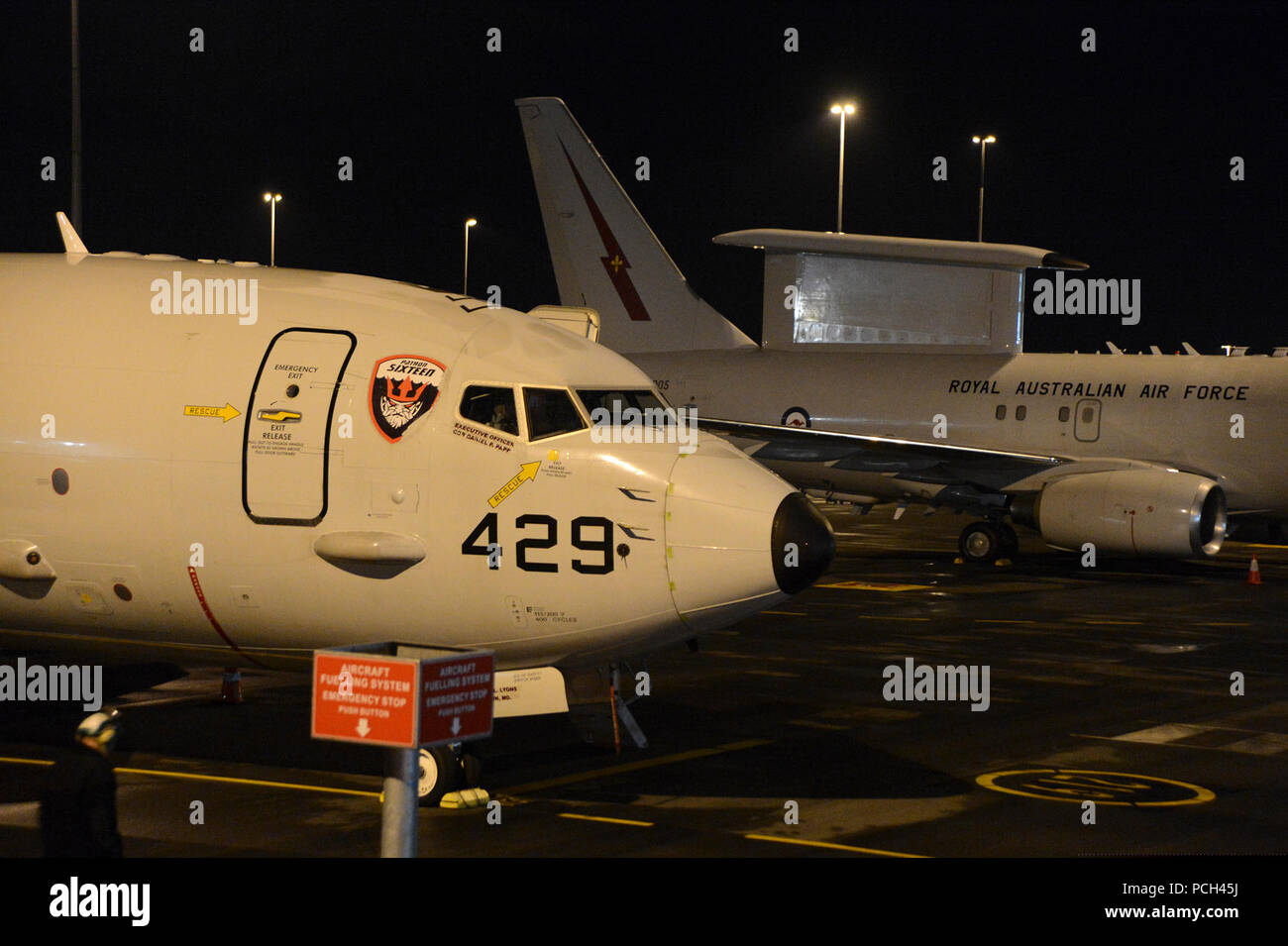 A P-8A Poseidon airplane from Patrol Squadron (VP) 16 sits next to a Royal Australian Air Force E-7A Wedgetail airplane at Perth Airport. Both planes are being utilized for the international effort to locate Malaysia Airlines flight MH370. VP-16 is deployed in the U.S. 7th Fleet area of responsibility supporting security and stability in the Indo-Asia-Pacific region. Stock Photo