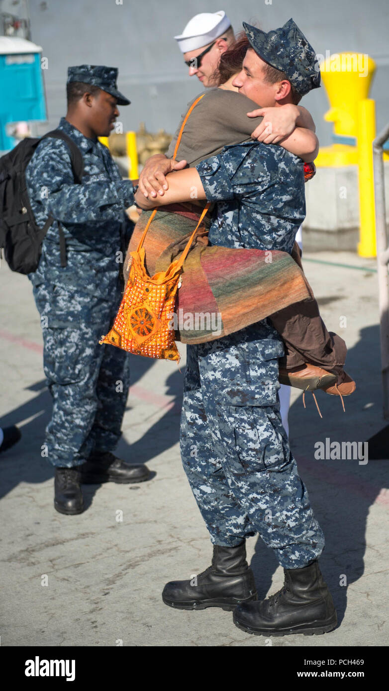 SAN DIEGO (APRIL 10, 2014)- A Sailor assigned to the Oliver Hazard Perry-class guided-missile frigate USS McClusky (FFG 41) gets one last hug from his loved ones before departing on a scheduled deployment. The McClusky is expected to play an integral part in counter-transnational organized crime mission Operation Martillo. Stock Photo