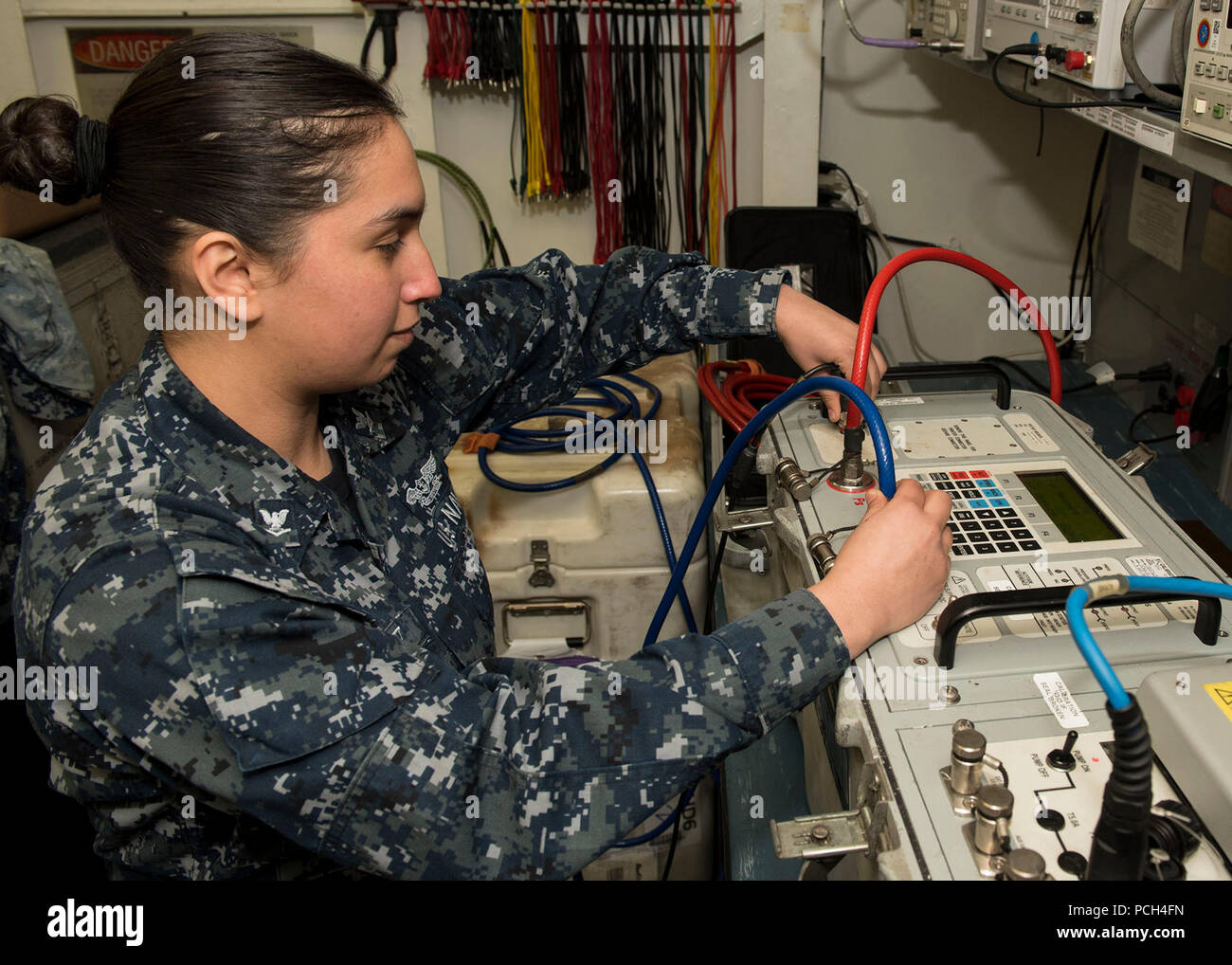 SASEBO (Jan. 3, 2017) Aviation Electronics Technician 3rd Class Jessica Martinez checks the connections on an air data test set aboard amphibious assault ship USS Bonhomme Richard (LHD 6). The ship is forward-deployed to Sasebo, Japan, serving forward to provide a rapid-response capability in the event of a regional contingency or natural disaster. Stock Photo