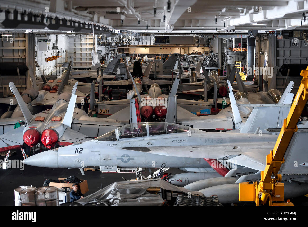 PACIFIC OCEAN (April 17, 2018) Aircraft sit in the hangar bay of the aircraft carrier USS Theodore Roosevelt (CVN 71). Theodore Roosevelt is underway for a regularly scheduled deployment in the U.S. 7th Fleet area of operations in support of maritime security operations and theater security cooperation efforts. Stock Photo