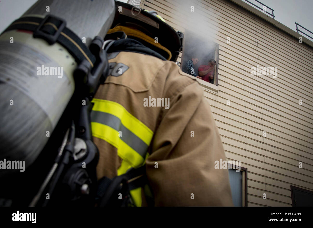 DIEGO (July 15, 2015) - Boatswain’s Mate 1st Class Ken Haley and Gunner’s Mate 3rd Class D’anthony Early-Riley participate in a simulated rescue as part of an aircraft mishap exercise designed to test response and rescue capabilities of Naval Air Station North Island first responders and their mutual aid partners within the San Diego region. The exercise presented a scenario of an aircraft crashing into a building causing fatalities and severe personnel injuries as well as extensive fire and structural damage. Stock Photo