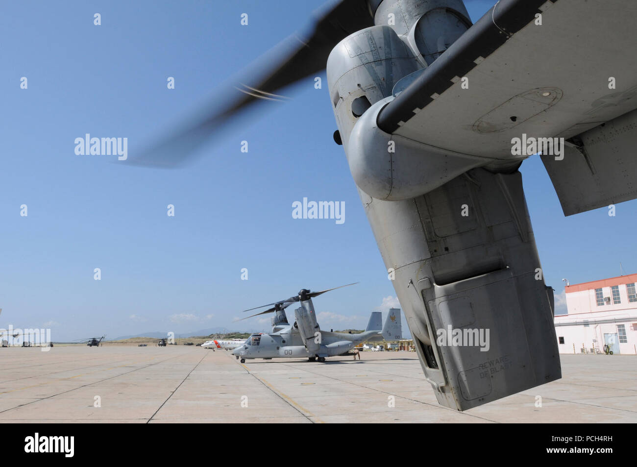 A MV-22 Osprey, from the Marine Medium Tiltrotor Squadron 162, waits for supplies at U.S. Naval Station Guantanamo Bay, Jan. 24. The aircraft, scheduled to fly a mission to USS Bataan, is here in support of Operation Unified Response to provide humanitarian assistance to victims of the Jan. 12 earthquake in Haiti. Stock Photo