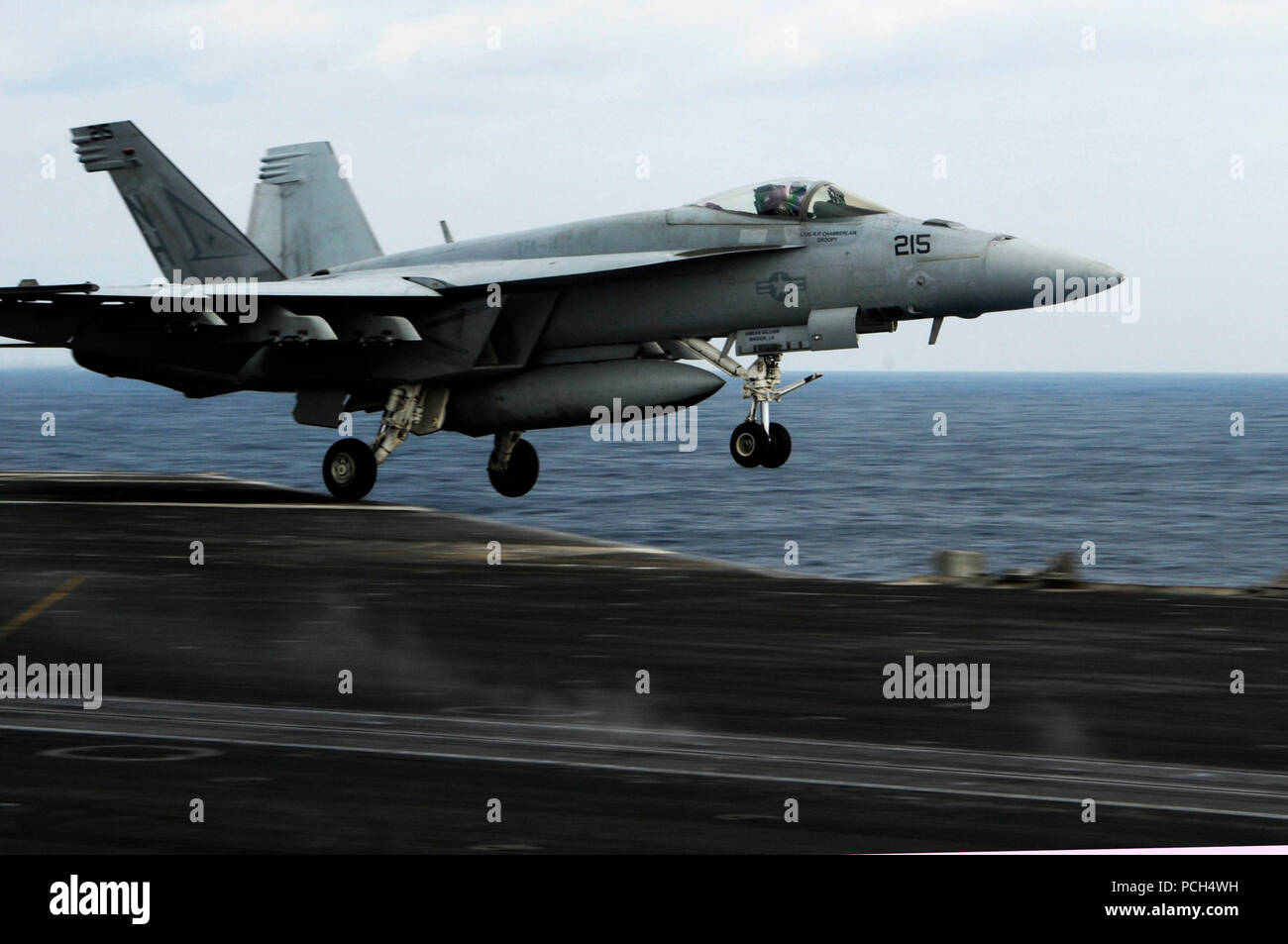An F/A-18E Super Hornet assigned to the 'Tophatters' of Strike Fighter Squadron 14 launches from the flight deck aboard the aircraft carrier USS Nimitz. The Nimitz Carrier Strike Group is conducting operations in the U.S. 7th Fleet area of responsibility in support of Maritime Strategy. Stock Photo