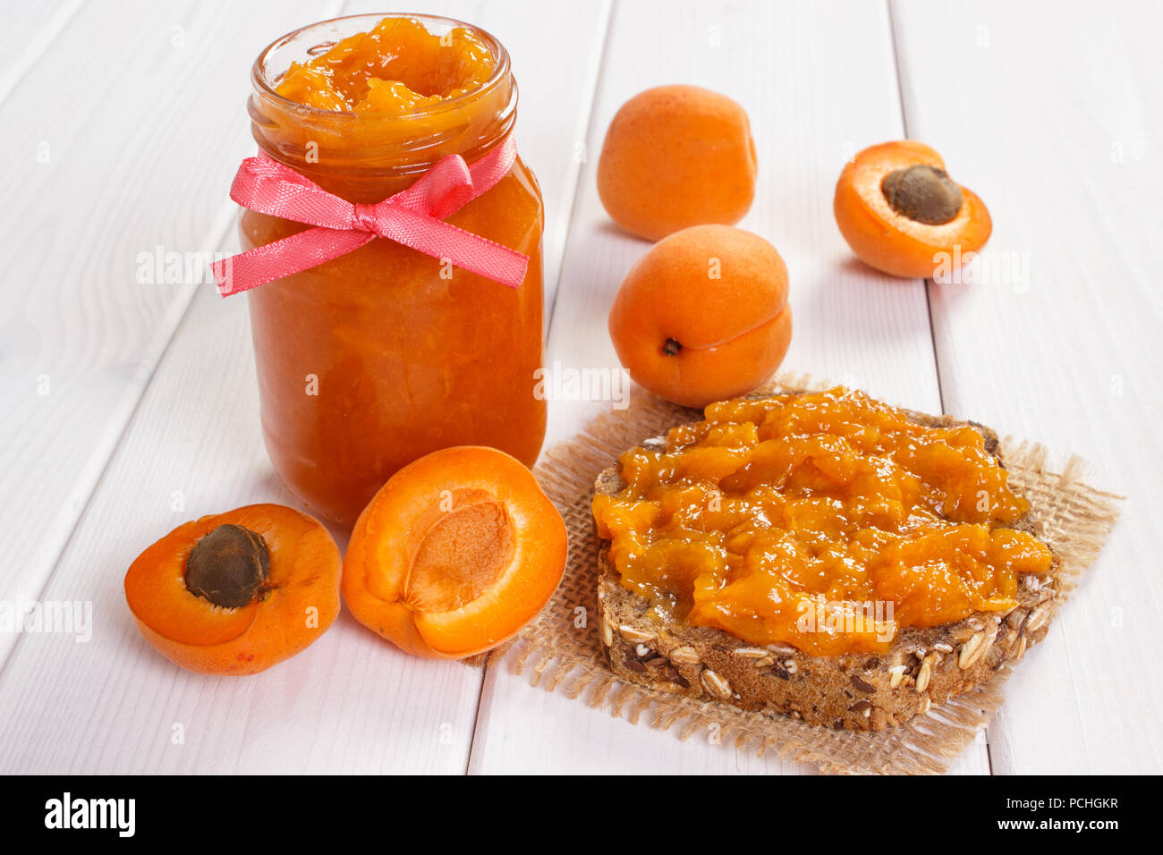 Fresh prepared sandwich with apricot jam or marmalade and ripe fruits, concept of healthy sweet dessert Stock Photo
