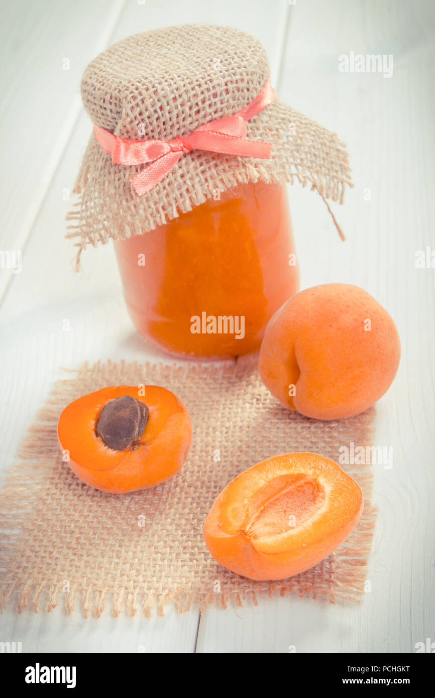 Vintage photo, Fresh prepared apricot jam or marmalade and ripe fruits, concept of healthy sweet dessert Stock Photo