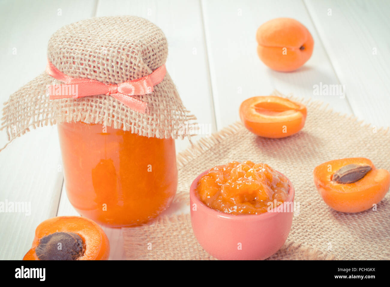 Vintage photo, Fresh prepared apricot jam or marmalade and ripe fruits, concept of healthy sweet dessert Stock Photo