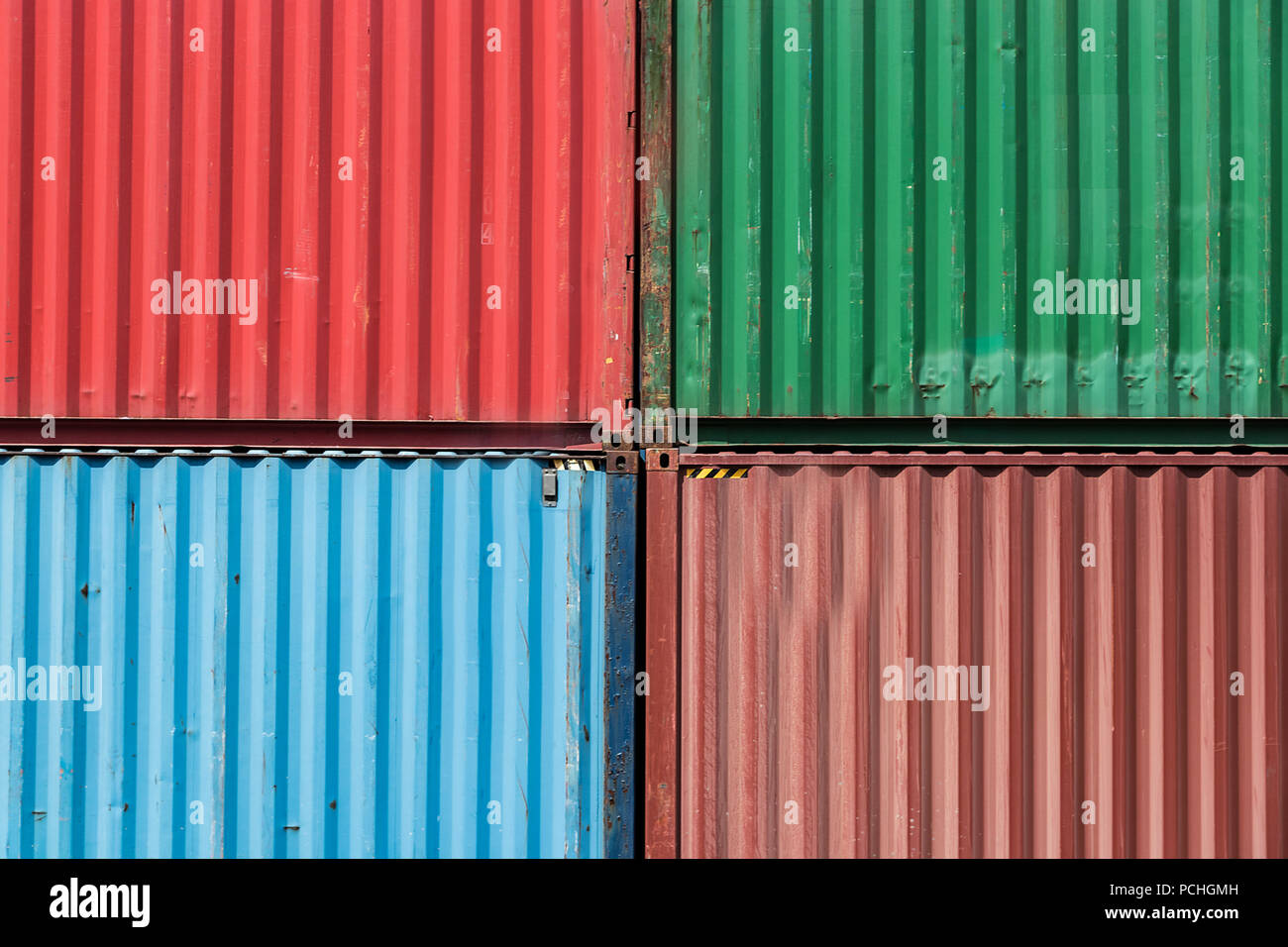 Four shipping containers stacked, rectangular pattern, green, blue and red colors. Stock Photo