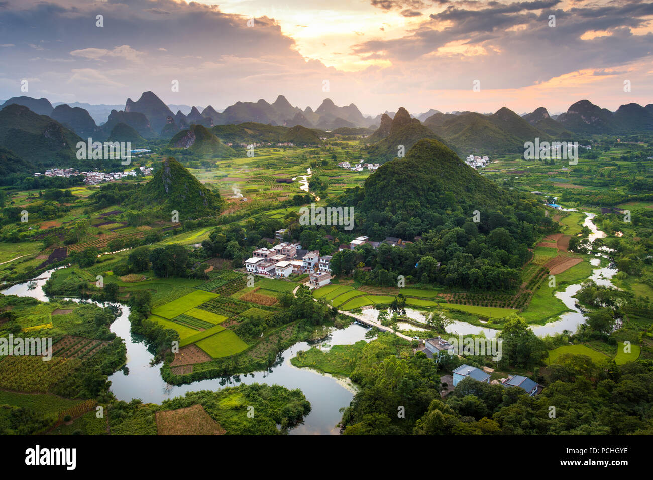 Stunning sunset over karst formations and rice fields landscape near Yangshuo in Guangxi province of China Stock Photo