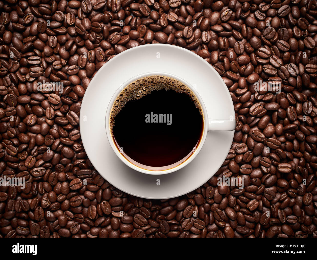 Cup of coffee on top of coffee beans Stock Photo Alamy