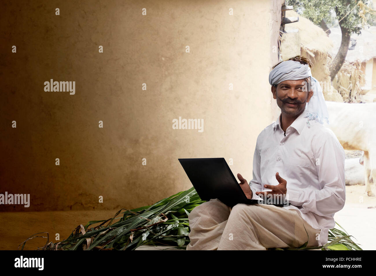 Indian rural farmer using laptop Stock Photo
