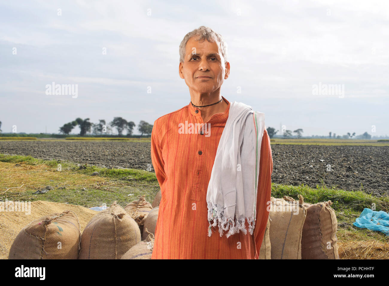 Portrait of farmer standing in paddy field Stock Photo