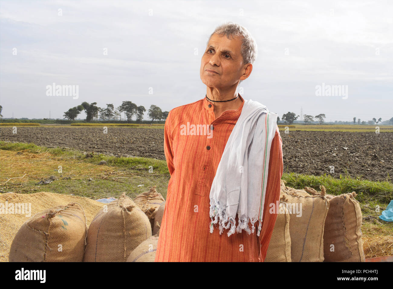 Portrait of farmer standing in paddy field Stock Photo