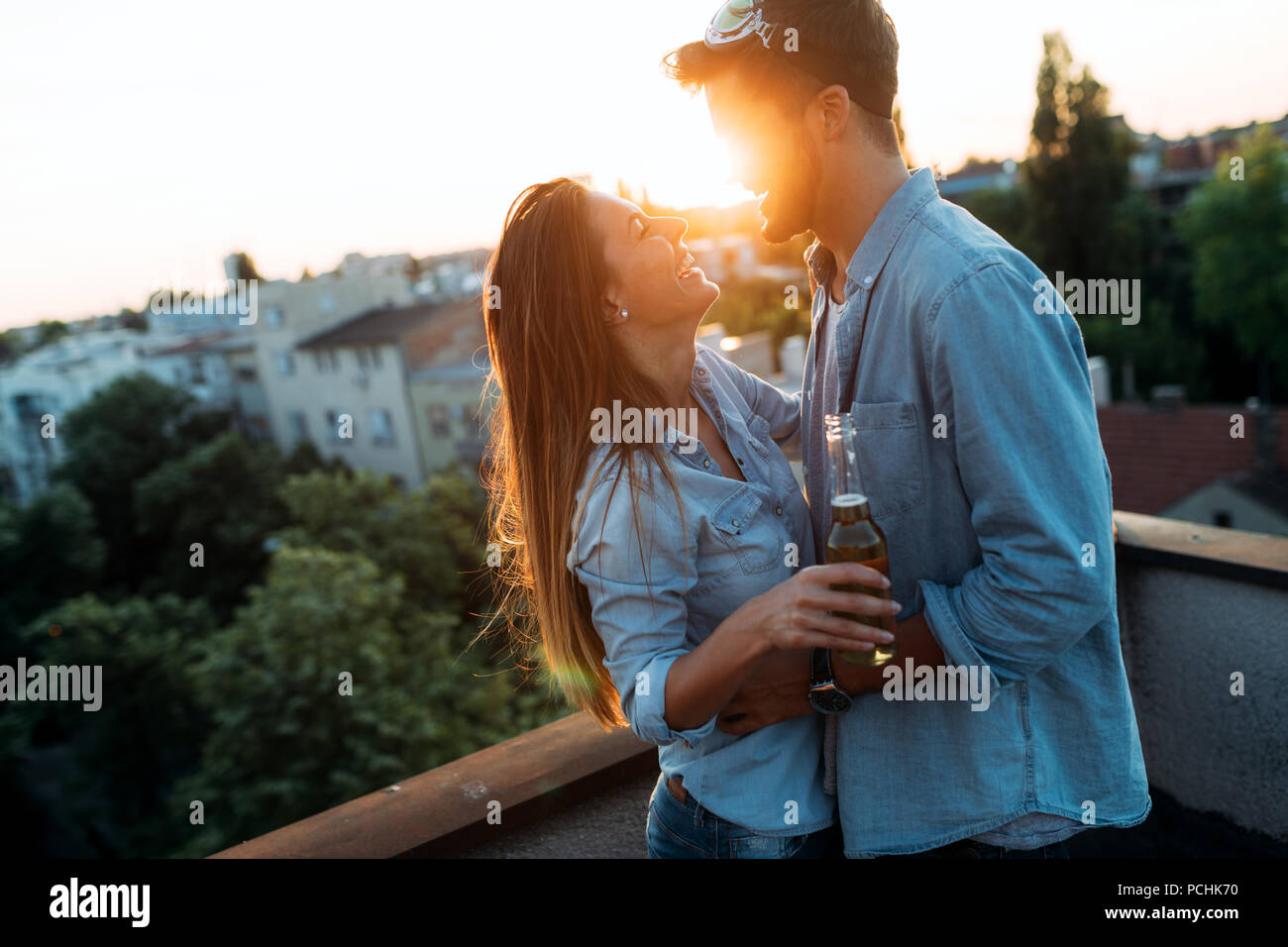 Couple flirting while having a drink on rooftop terrasse Stock Photo