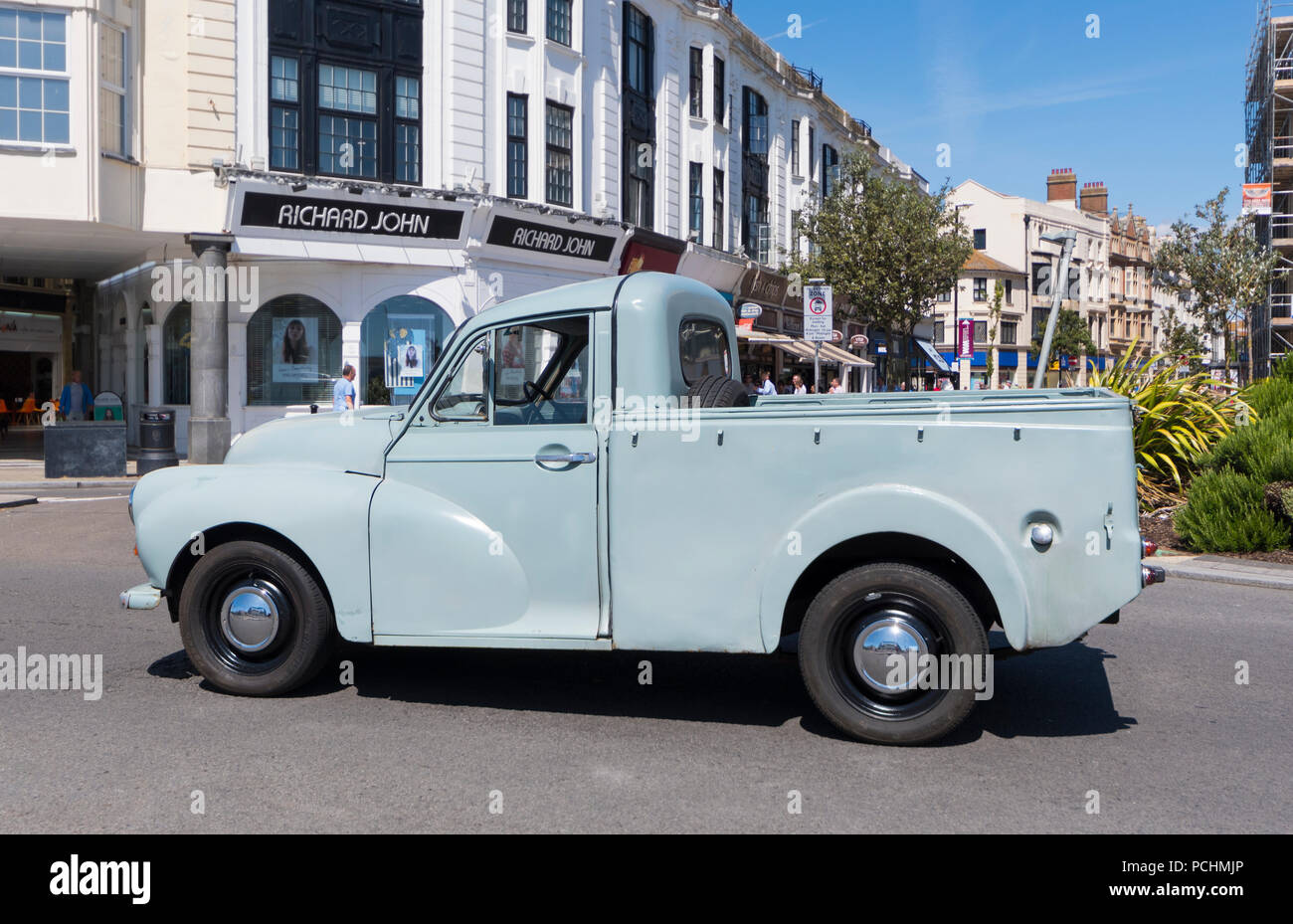 Old Morris Minor pickup truck from 1968 after restoration, on a British road in England, UK